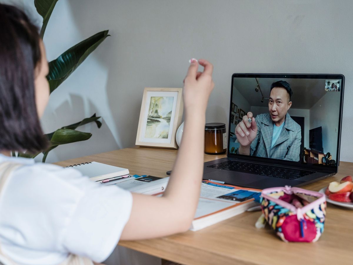 Tutor teaching a student remotely over a video call